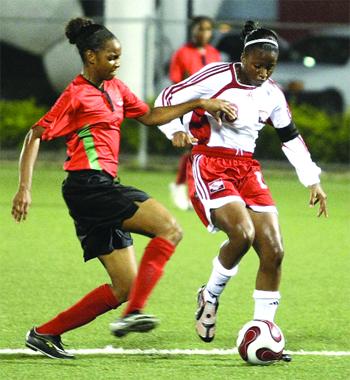 ﻿T&T U-20 captain, Mariah Shade, is challenged by St Kitts/Nevis player, Shandor Wilkinson, during the CFU final round qualifier at the Marvin Lee Stadium (MLS), Macoya on Wednesday night. T&T won 6-0, with Shade scoring two goals. Photo: Anthony Harris.